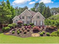 Charming two-story home with lush landscaping and a well-manicured front yard at 6209 Benbrooke Dr, Acworth, GA 30101