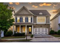 Charming two-story home featuring stone accents, blue shutters and a welcoming front porch at 3380 Labrouste Cv, Duluth, GA 30097