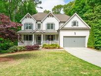 Beautiful two-story home with a covered front porch, well-manicured lawn and two-car garage at 4910 Conover Dr, Atlanta, GA 30338