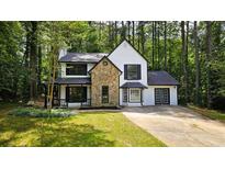 Charming two-story home featuring a stone accent facade and white siding at 381 Fleming Ct, Jonesboro, GA 30238