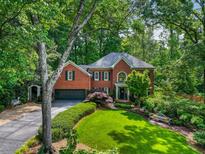 Stately brick home with mature landscaping and a well-manicured front yard offers great curb appeal at 1676 Grove Park Way, Decatur, GA 30033