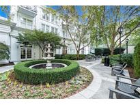 Beautiful courtyard with fountain, lush landscaping, and seating areas creates a serene outdoor space at 195 14Th St # 1501, Atlanta, GA 30308