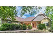 Charming single-Gathering home with a covered porch, brick accents, and well-manicured landscaping at 255 Nicklaus Cir, Social Circle, GA 30025