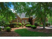 Charming brick home with manicured landscaping and mature trees offers great curb appeal at 1187 Ward Creek Sw Dr, Marietta, GA 30064