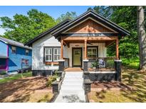 Charming home with a welcoming front porch, modern black and white paint scheme, and inviting curb appeal at 958 Crew Sw St, Atlanta, GA 30315