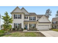 Beautiful two-story home boasts traditional design, a blue front door, lush lawn and a two-car garage at 265 Riverclub Rd, Acworth, GA 30101