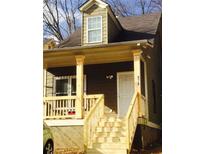 Charming craftsman-style home featuring a covered front porch, wooden steps, and fresh paint at 476 Elm Nw St, Atlanta, GA 30318