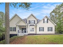 Charming two-story home with landscaped front yard and inviting entrance, enhanced by blue skies and mature trees at 4835 Liberty Rd, Villa Rica, GA 30180