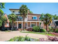 Stunning two-story home featuring palm trees, a tile roof, brick accents, and a circular driveway at 1216 E Rock Springs Ne Rd, Atlanta, GA 30306