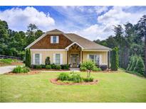 Charming single-Gathering home showcasing a manicured lawn and welcoming front exterior at 608 Red Leaf Way, Canton, GA 30114