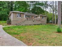 Charming single-story home with a spacious front yard and inviting entrance staircase at 1304 Anchor Sw Ter, Atlanta, GA 30311