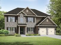 Charming two-story home featuring a mix of stone and siding, complemented by a well-manicured lawn and a two car garage at 3272 Lions Ruby Ln, Atlanta, GA 30349