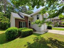 Charming two-story home featuring a brick accent, well-manicured lawn, and a two-car garage at 3838 Glenlake Springs Nw Ct, Kennesaw, GA 30144