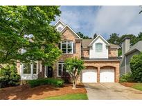 Charming two-story brick home with a well-manicured lawn and a two-car garage at 3220 Millwood Se Trl, Smyrna, GA 30080