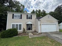 Charming two-story home with attached garage and neutral siding at 675 Stonebridge Loop, Lithonia, GA 30058