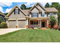 Charming home with a manicured lawn, two-car garage, and welcoming front porch at 1120 Bentwater Dr, Acworth, GA 30101
