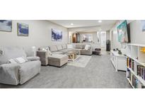 Spacious living room with a large comfortable sectional couch, soft rug, and modern decor at 4216 Stillwater Dr, Duluth, GA 30096