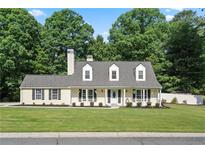 Charming single-Gathering home with a manicured lawn and beautiful landscaping, exuding curb appeal at 710 Crab Orchard Ct, Roswell, GA 30076