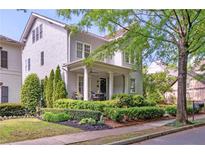 Charming two-story home features a covered porch with manicured landscaping at 6575 Eli Davis Rd, Cumming, GA 30040