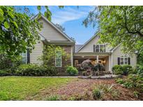 Charming home with stone accents, manicured lawn, and lush landscaping at 1495 Old Hunters Lake Dr, Marietta, GA 30062