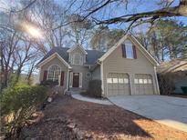 Charming home featuring a two-car garage, well-maintained landscaping, and a welcoming entrance at 2887 Royal Blf, Decatur, GA 30030
