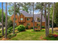Charming brick home with a well-manicured lawn and mature trees in a desirable neighborhood at 3358 Stovehill Se Ct, Marietta, GA 30067