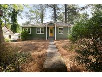 Charming single-story home with a green exterior, well-maintained lawn, and inviting yellow front door at 720 Maynard Se Ter, Atlanta, GA 30316