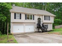 Charming two-story home featuring a two-car garage and welcoming front porch at 5174 Ridge Tarn, Acworth, GA 30102