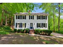 Charming two-story home featuring a bright exterior, complemented by lush greenery and a well-maintained front yard at 51 Queen Anne Se Dr, Mableton, GA 30126