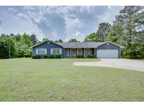 Charming ranch-style home with a well-maintained lawn and inviting curb appeal at 203 Leigh Dr, Ellenwood, GA 30294