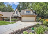 Charming Tudor-style home with a well-manicured lawn, brick accents and attached two-car garage at 12 Westchester Square Sq, Decatur, GA 30030
