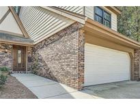 Charming brick home featuring an attached two-car garage and a traditional-style front door at 12 Westchester Square Sq, Decatur, GA 30030