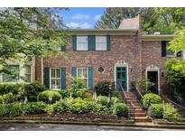 Charming brick townhouse with green shutters and meticulously landscaped front yard at 1534 September Chase, Decatur, GA 30033