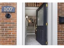 Inviting entryway featuring a black front door with glass and a glimpse of the home's interior at 1634 Ponce De Leon Ave # 107, Atlanta, GA 30307