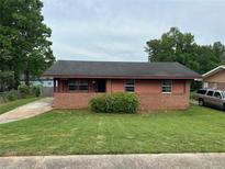 Charming single-story home featuring a brick facade, cozy porch, and well-maintained lawn at 4009 Ester Sw Dr, Atlanta, GA 30331