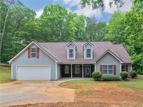 Charming single-Gathering home with gray siding, red shutters, attached garage, and a well-manicured front lawn at 445 Royal St, Mcdonough, GA 30253