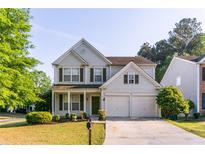 Charming two-story home with landscaped yard and two-car garage at 312 Burdock Trce, Woodstock, GA 30188