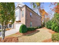 Brick two-story home featuring an attached garage and manicured lawn, perfect for suburban living at 5260 Cresslyn Rdg, Alpharetta, GA 30005