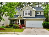 Charming two-story home with stone accents, lush landscaping, and a two-car garage at 1218 Matt Moore Ct, Lithia Springs, GA 30122