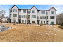 Beautiful new row of townhomes showcasing a modern black and white exterior design on a well-manicured lawn at 1358 Pavilion Se Ct, Atlanta, GA 30316