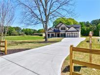 Charming new construction home featuring a long driveway and inviting two-story facade at 3132 Rosebud Rd, Loganville, GA 30052