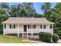 Charming single-story home with a welcoming front porch and a well-maintained yard at 39 Spring Leaf Pl, Dallas, GA 30157