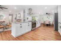Bright, modern kitchen features granite countertops, white cabinets, and stainless steel appliances at 4807 Kenilworth Dr, Stone Mountain, GA 30083