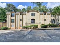 Three-story apartment building with brick facade, well-maintained landscaping, and ample parking at 5400 Roswell Rd # N1, Sandy Springs, GA 30342