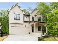 Stunning two-story home boasting a neutral palette, black trim windows, a covered front porch, and an attached two-car garage at 253 Rockyford Ne Rd, Atlanta, GA 30317