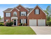 Charming two-story brick home featuring a manicured front lawn and a two-car garage at 3477 Seneca Farm Dr, Buford, GA 30519