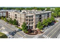 Stunning exterior view of a well-maintained condominium building with tree-lined sidewalks at 50 Canton St # 406, Alpharetta, GA 30009