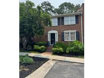 Charming brick townhome entrance with manicured landscaping and inviting walkway at 4620 Wieuca Ne Rd # 42, Atlanta, GA 30342