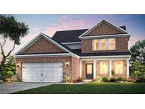 Charming two-story brick home with a manicured lawn, attached two car garage, and covered front porch at 1651 Tide Mill Rd, Cumming, GA 30040