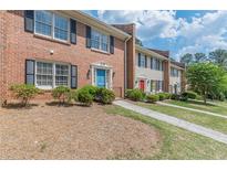 Charming brick townhomes featuring well-maintained lawns and colorful front doors at 4101 Dunwoody Club Dr # 49, Atlanta, GA 30350